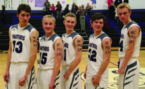 Panther Players show respect for Park County police deputies during their game with Platte Canyon (r to l) #13 Brad Lutz, #15 Chance Martin, #11 Doug Dean, #32 Brandon Wylie, #14 Ryan Jones. photo credit Chad Fossen
