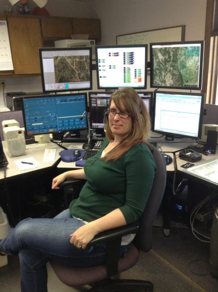 Jodie Kern, a 17 year veteran emergency dispatcher sits in front of some of the monitors in her position in the communications center at the Grand County Sheriff’s Office.
