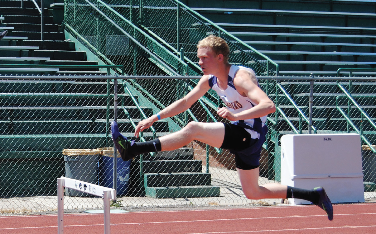 photo by Garrett Miller West Grand senior Josh O'Hotto keeps a steady pace in the hurdles to earn third.