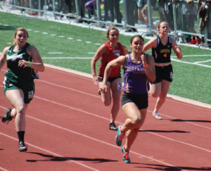 photo by Susan Ritschard West Grand senior Ralin Corrales finishes strong in the 100 meter dash during the Western Slope League in Grand Junction. She placed fifth in the 100 meter dash and won the pole eventing with a 9-4 jump.