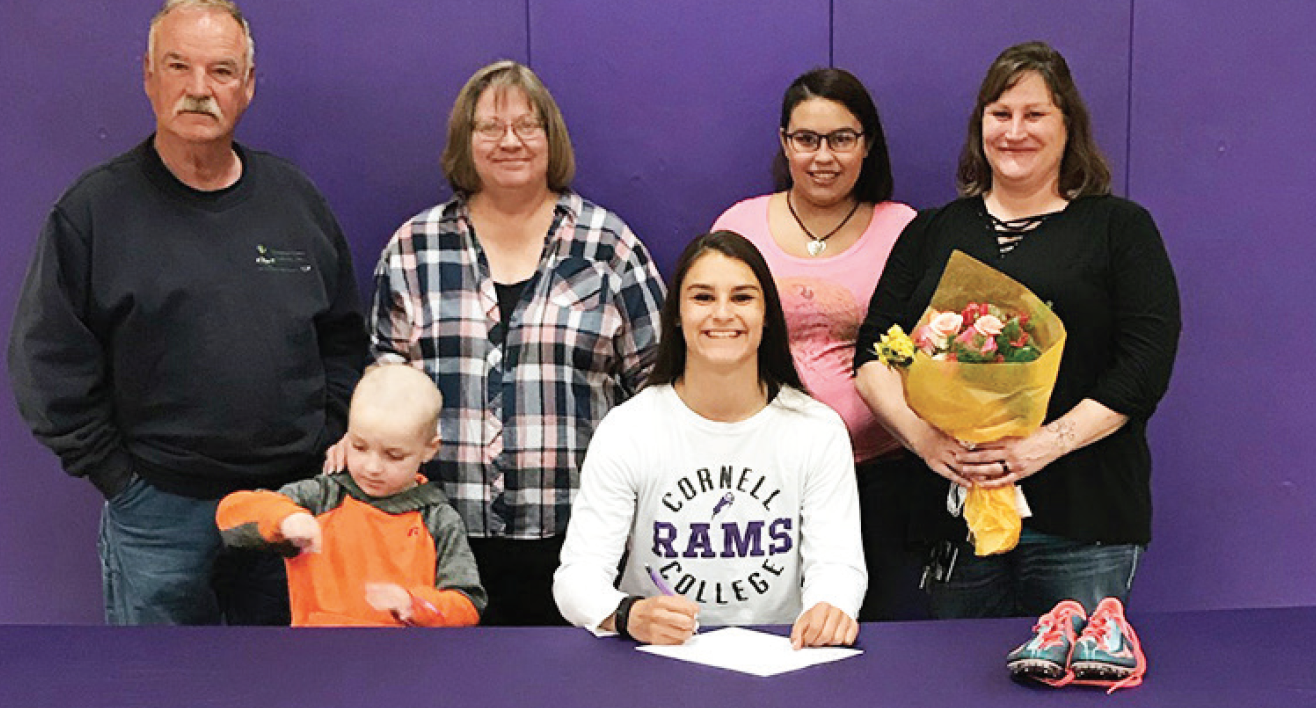 photo by Sydney Ritschard Ralin Corrales (front center) was joined by her family at her official signing for Cornell Univeristy. (Back L to R) Grandparents Sam and Laurie Henderhan, sister Erika Moffat, ,mother Krisit Moffat and (Front L to R) brother James Moffat and Corrales.