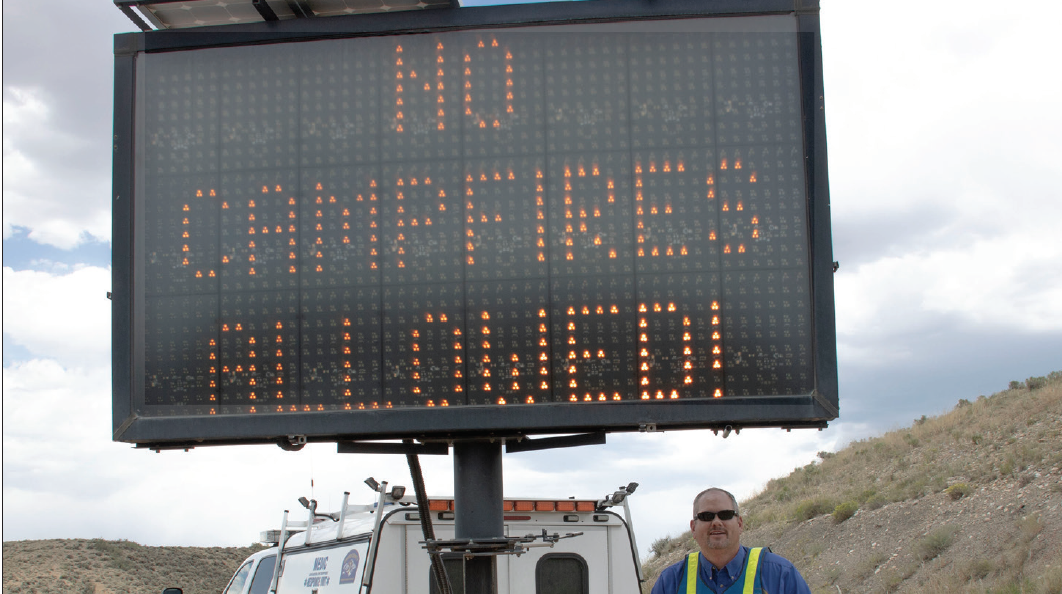 photo by Kim Cameron Grand County Emergency Manager Christian Hornbaker sets-up an electronic message board on July 3 to alert travelers into the county about Stage 2 fire restrictions. Similar messages were seen along I-70 in Clear Creek County and Summit County.