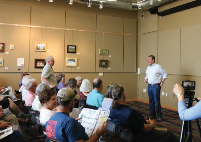 by Tara Walker Senator Michael Bennet answered a myriad questions about healthcare, college costs, Planned Parenthood and more during a town hall meeting at the Granby Library on August 9.
