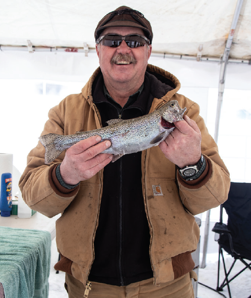 photo by Kim Cameron | Steve                            Schake shows his winning
fish.