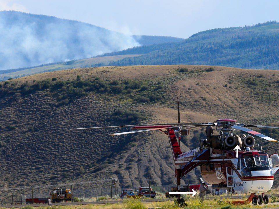 Not just any helicopters are used for fire fighting. Notice the arrows pointing at the crew. The Dice Hill Fire is still active as the crew serviced their helicopter, while a second remained on the attack. Thank you fire fighters!