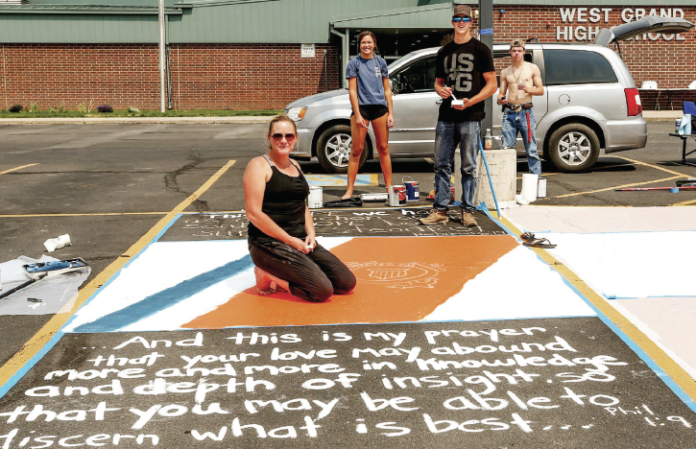 The class of 2021 is ready to step out into the world. This year the seniors painted their parking spots. The school approved the plan presented by a group of 2021 senior parents. The school then had the future graduates chose their parking spot and approved their design. (Left to Right) Kelley Rice, Alex Schake, Austin Schake, and Carson Culbreath.