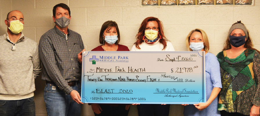 photo by Tiffany Freitag | The Middle Park Medical Foundation presented the Kremmling Memorial Health Board members with a check for $21,978.30. Middle Park Health plans to construct a 1,200 square-foot infusion center at the Granby campus with one private room and three free-standing pods for antibiotic, immunoglobulin, and chemo therapies. This capital project is not funded by the USDA loans acquired for the current expansion projects and is reliant on donations and other funding sources. (L to R) Andy Radzavich and Frank DeLay of the Foundation and KMH Board Members Chris Murphy, Joid Decheff, Kelie Johnson, and Kim Cameron