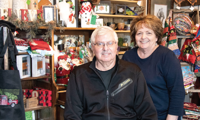 photo by Kim Cameron Randy and Jerri Thornton, owners of Keepsake Christmas Shoppe, proudly display crafts from local artisans in their shop.