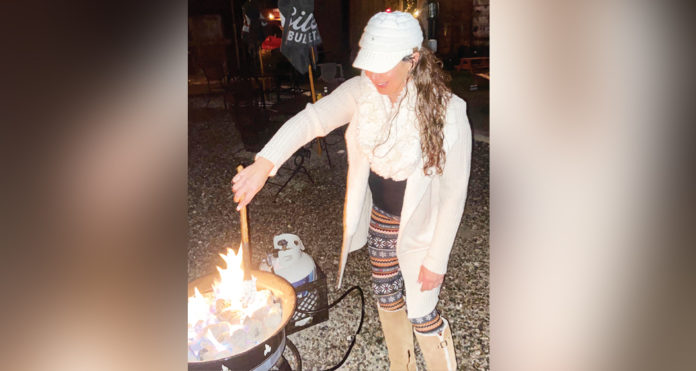 Amelia Benson demonstrates how to put the Amelia’s Campfire Pretzel into the flame for the best results.