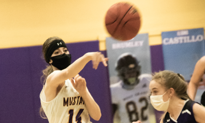 Junior Audrey Wheatley drives the ball down the court as she passes off to teammates. The Mustangs were dominated in the home #unitedinpurple game earlier this week. Mustang high scorer in the game was senior Iliana Castillo with 6 points.