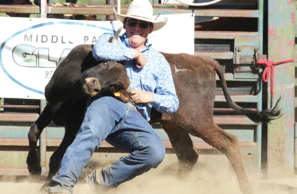 photo by Kim Cameron | Foster Krempin dogs his steer out the chtue. This event does not require a horse.