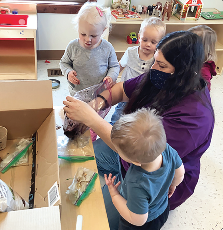 photo courtesy of West Grand Early Childhood Center | Early childhood educator, Sabrina Rivera ensures that young toddlers have many hands-on experiences at the West Grand Early Childhood Center.